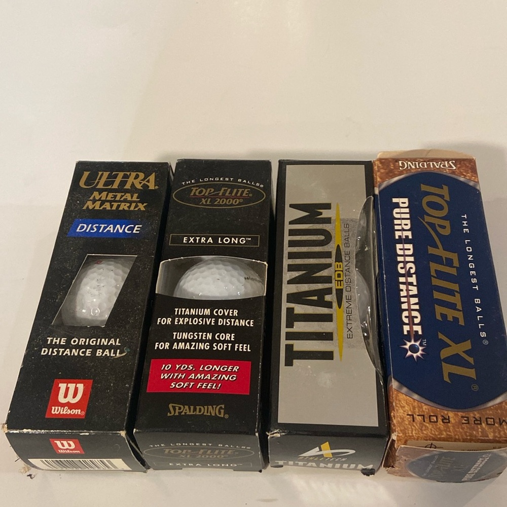 12 assorted golf balls new in the box